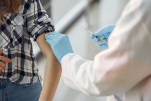 Provider preparing to give a person vaccine shot