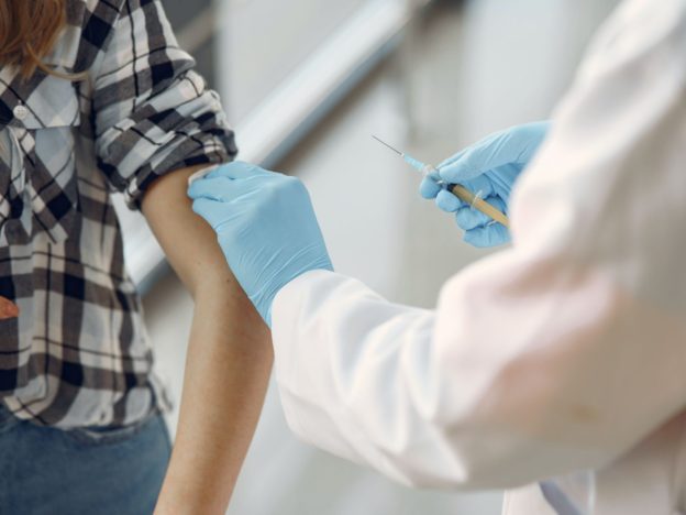 Provider preparing to give a person vaccine shot
