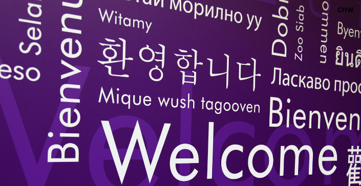 Purple background with the word Welcome in several languages.