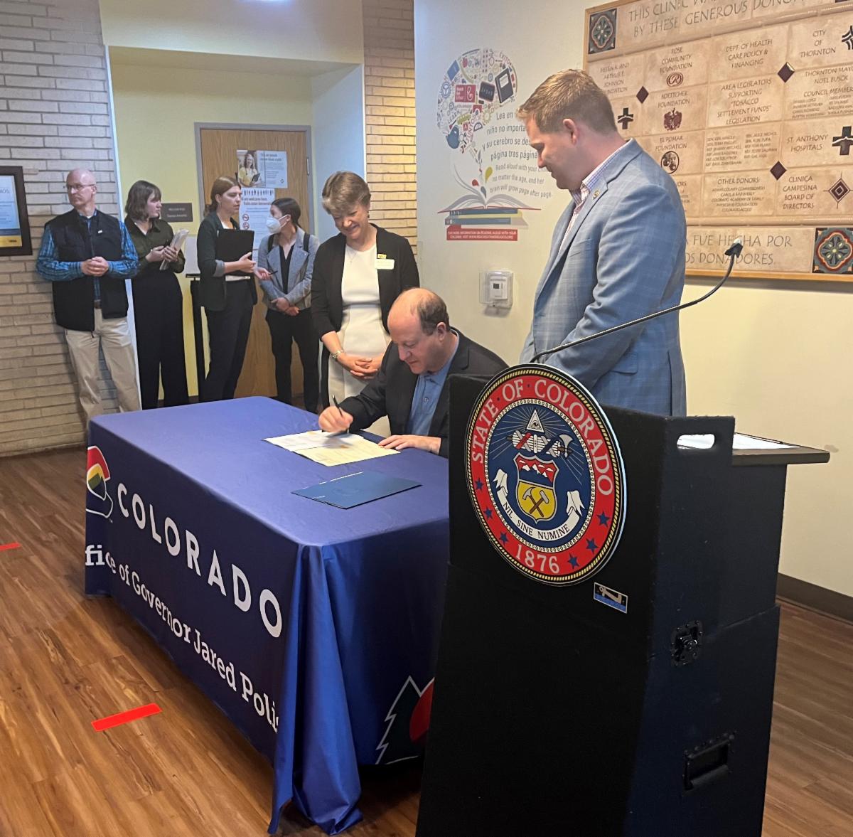 Colorado Gov. Polis signs the CHW bill. 